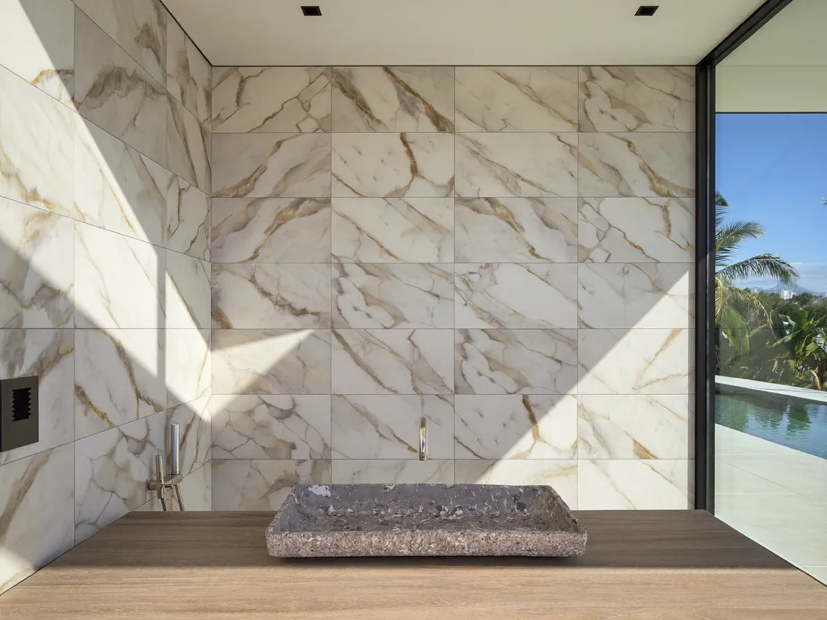 Large-format marble-look tiles installed in a luxury Bali villa bathroom